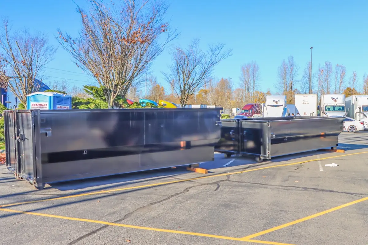 Professional dumpster rental service with roll-off container on residential driveway in Lake Charles